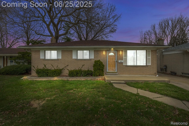 22323 Gordon Rd, Saint Clair Shores, MI 48081 - view of front facade featuring a chimney, brick siding, and a lawn