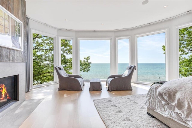 9182 Hemlock Ln, Bridgman, MI 49106 - bedroom with a water view, a premium fireplace, access to exterior, and wood finished floors