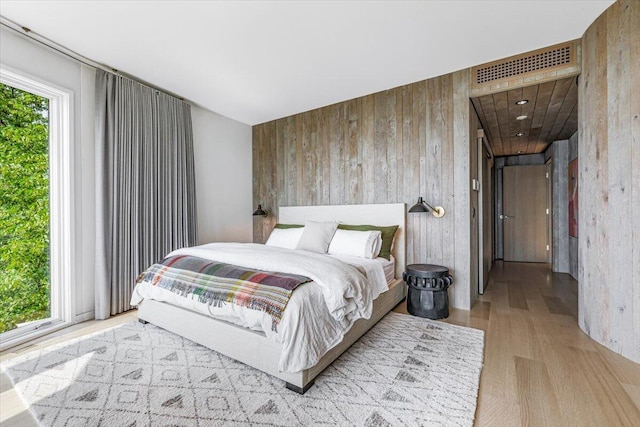 9182 Hemlock Ln, Bridgman, MI 49106 - bedroom with wooden walls and wood finished floors
