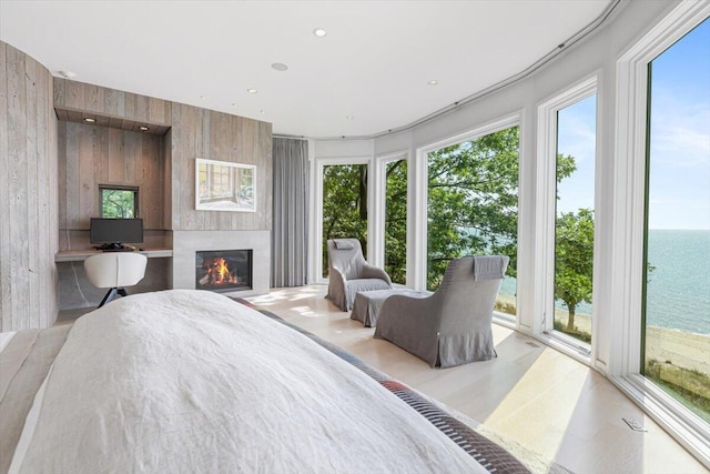 9182 Hemlock Ln, Bridgman, MI 49106 - bedroom featuring access to outside, a water view, a glass covered fireplace, and wood walls