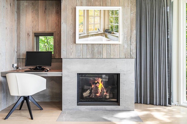 9182 Hemlock Ln, Bridgman, MI 49106 - office area featuring a fireplace with flush hearth and wood finished floors