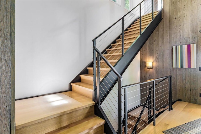 9182 Hemlock Ln, Bridgman, MI 49106 - stairway featuring wooden walls and a high ceiling