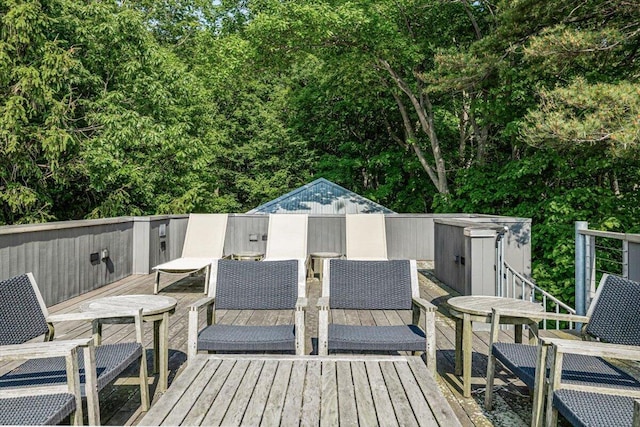 9182 Hemlock Ln, Bridgman, MI 49106 - wooden deck with outdoor dining space and a storage unit
