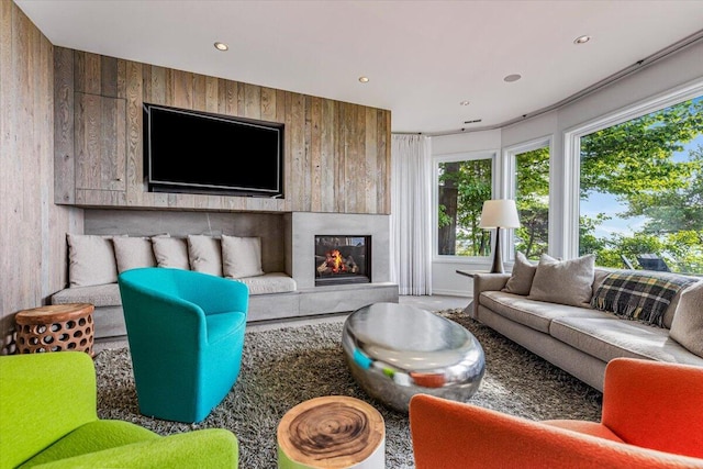 9182 Hemlock Ln, Bridgman, MI 49106 - living room with wooden walls, recessed lighting, and a glass covered fireplace