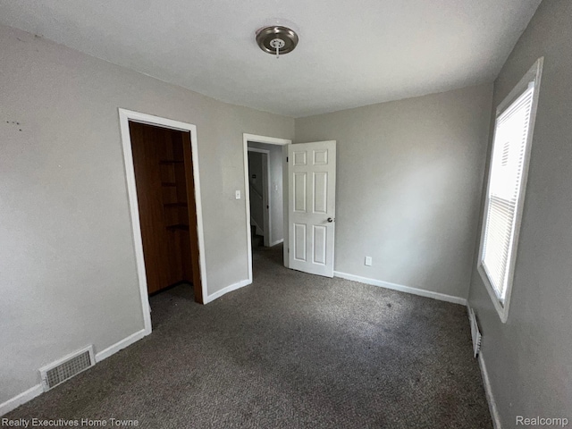 19738 Westphalia St, Detroit, MI 48205 - unfurnished bedroom featuring dark colored carpet and baseboards