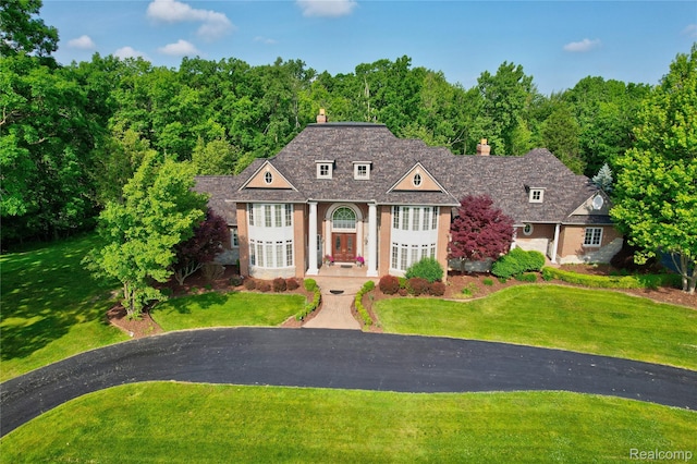 8356 Misty Mdws, Grand Blanc, MI 48439 - view of front of property with a chimney and a front lawn