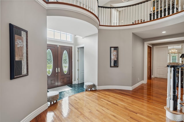 8356 Misty Mdws, Grand Blanc, MI 48439 - foyer with a high ceiling, wood finished floors, and a chandelier