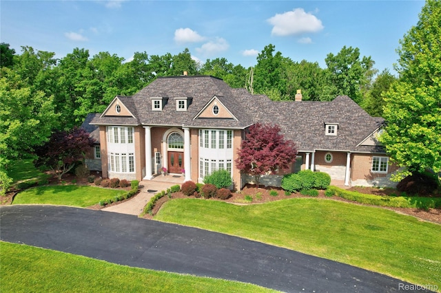 8356 Misty Mdws, Grand Blanc, MI 48439 - view of front facade with a front lawn, a chimney, and brick siding