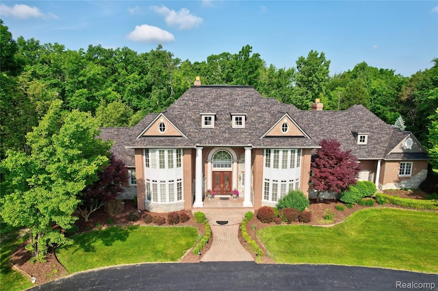 8356 Misty Mdws, Grand Blanc, MI 48439 - view of front of property featuring a chimney, a front yard, and brick siding