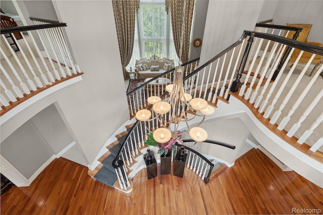 8356 Misty Mdws, Grand Blanc, MI 48439 - stairs with wood finished floors, a chandelier, and a towering ceiling