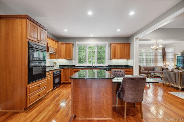 8356 Misty Mdws, Grand Blanc, MI 48439 - kitchen featuring dark countertops, light wood finished floors, backsplash, a center island, and open floor plan