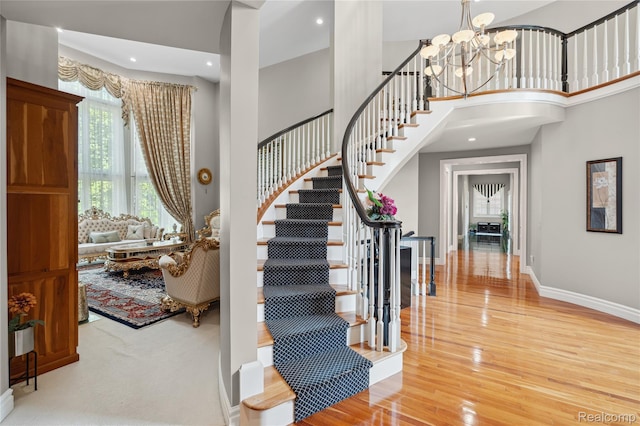 8356 Misty Mdws, Grand Blanc, MI 48439 - foyer entrance with a chandelier, stairs, wood finished floors, and a towering ceiling