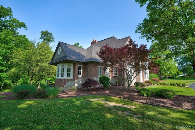 8356 Misty Mdws, Grand Blanc, MI 48439 - view of front facade featuring brick siding, a front yard, and a chimney