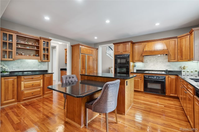 8356 Misty Mdws, Grand Blanc, MI 48439 - kitchen with a kitchen bar, premium range hood, decorative backsplash, light wood finished floors, and recessed lighting