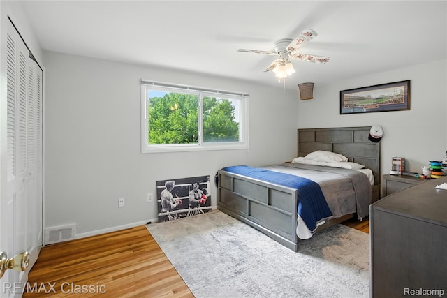 7027 Beverly Crest Dr, West Bloomfield, MI 48322 - bedroom featuring wood finished floors, a ceiling fan, and a closet