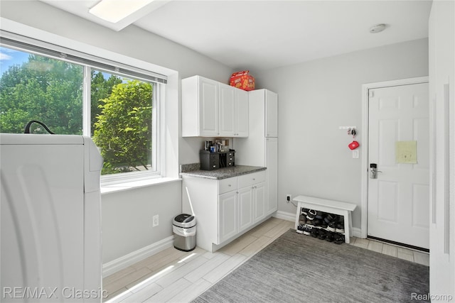 7027 Beverly Crest Dr, West Bloomfield, MI 48322 - kitchen with white cabinets and baseboards