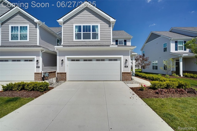 606 Angus Ln, Saline, MI 48176 - view of front of house featuring an attached garage, brick siding, and driveway