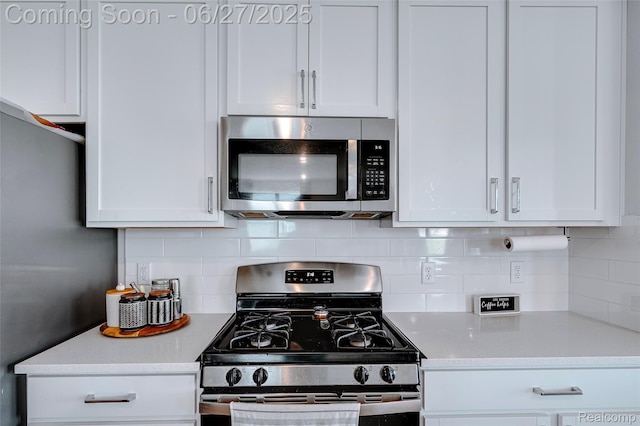 606 Angus Ln, Saline, MI 48176 - kitchen with appliances with stainless steel finishes, light countertops, white cabinets, and tasteful backsplash