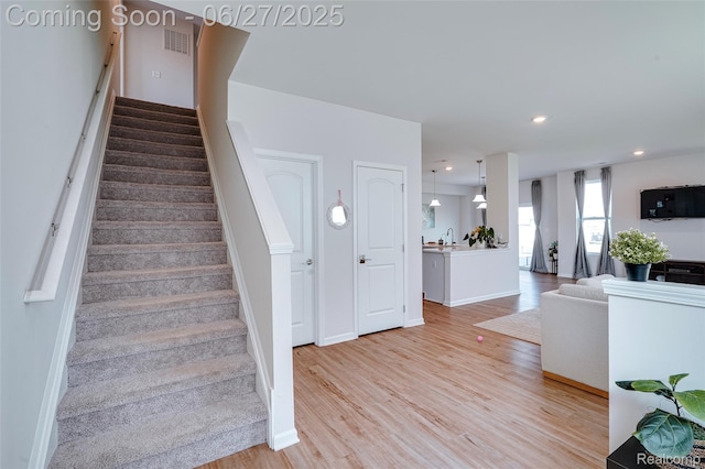 606 Angus Ln, Saline, MI 48176 - stairway with wood finished floors and recessed lighting