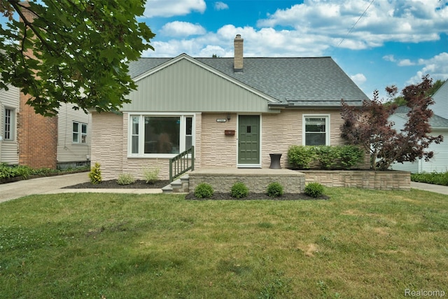 1566 Pearson St, Ferndale, MI 48220 - view of front facade featuring a front yard, stone siding, a chimney, and a shingled roof