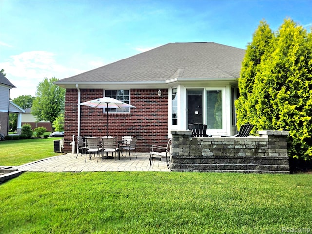 35260 Bradford Dr, New Baltimore, MI 48047 - back of property with a patio area, a yard, brick siding, and a shingled roof
