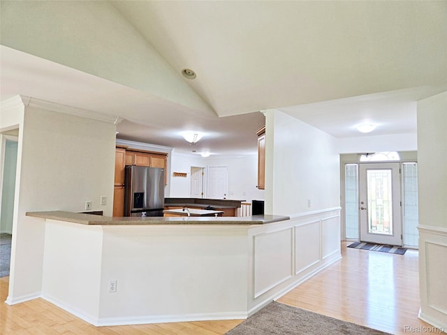 35260 Bradford Dr, New Baltimore, MI 48047 - kitchen featuring stainless steel fridge with ice dispenser, light wood finished floors, a peninsula, vaulted ceiling, and wainscoting
