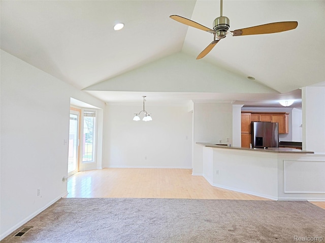 35260 Bradford Dr, New Baltimore, MI 48047 - unfurnished living room featuring light carpet, lofted ceiling, a chandelier, a ceiling fan, and recessed lighting
