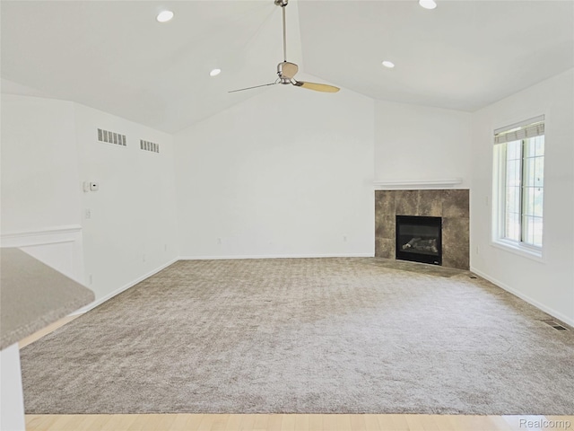 35260 Bradford Dr, New Baltimore, MI 48047 - unfurnished living room featuring lofted ceiling, ceiling fan, carpet, a tile fireplace, and recessed lighting