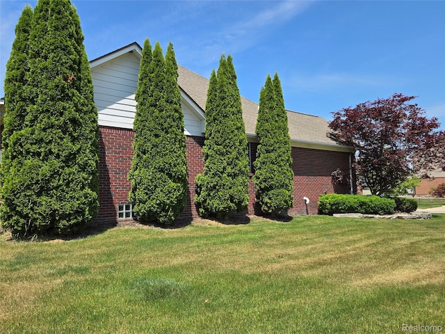 35260 Bradford Dr, New Baltimore, MI 48047 - view of side of property with brick siding, a yard, and a shingled roof
