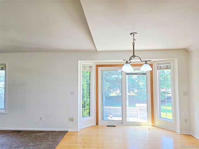 35260 Bradford Dr, New Baltimore, MI 48047 - unfurnished dining area with light wood-style flooring and a chandelier