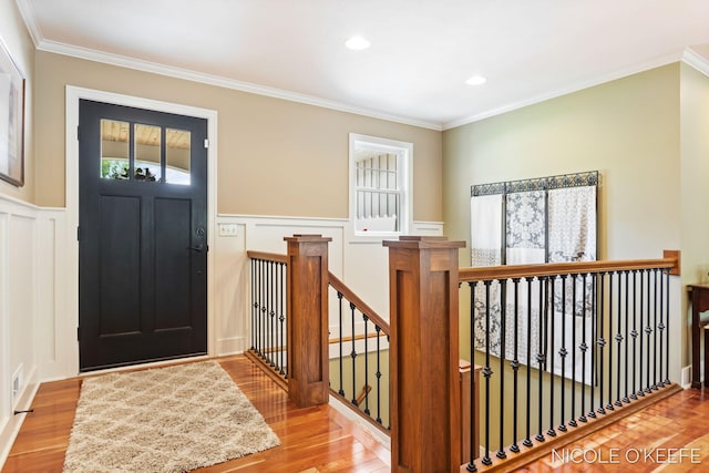 7150 Limerick Ln SW, Byron Center, MI 49315 - foyer featuring a decorative wall, wood finished floors, a wainscoted wall, and crown molding