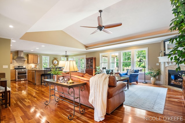 7150 Limerick Ln SW, Byron Center, MI 49315 - living area featuring a ceiling fan, wood finished floors, a fireplace, recessed lighting, and lofted ceiling