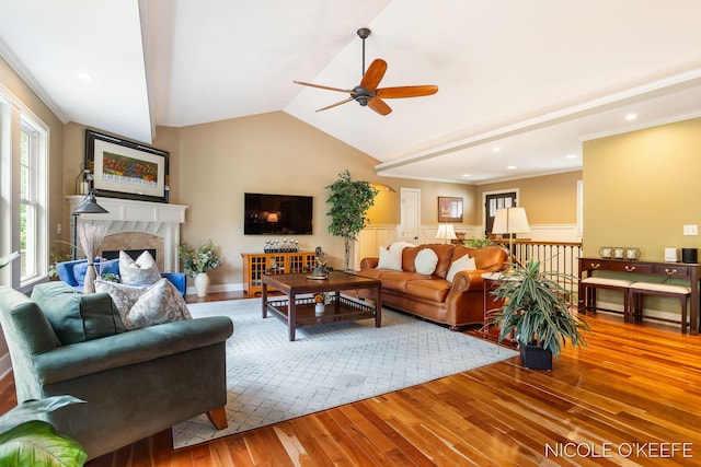 7150 Limerick Ln SW, Byron Center, MI 49315 - living area featuring hardwood / wood-style flooring, a ceiling fan, vaulted ceiling, a high end fireplace, and ornamental molding