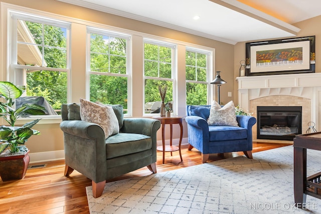 7150 Limerick Ln SW, Byron Center, MI 49315 - living room featuring wood-type flooring, ornamental molding, and a tiled fireplace