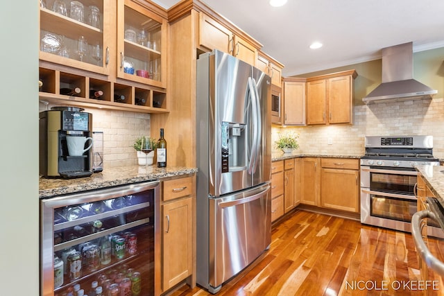 7150 Limerick Ln SW, Byron Center, MI 49315 - kitchen featuring appliances with stainless steel finishes, wall chimney exhaust hood, wine cooler, crown molding, and light wood-style flooring
