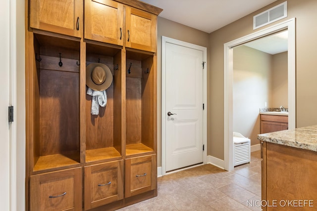 7150 Limerick Ln SW, Byron Center, MI 49315 - mudroom featuring a sink and light tile patterned floors