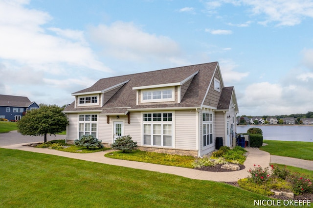 7150 Limerick Ln SW, Byron Center, MI 49315 - view of front facade with a front lawn, a water view, and a shingled roof