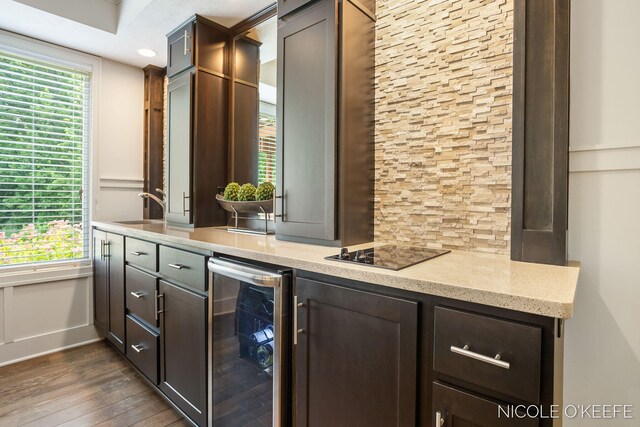 7150 Limerick Ln SW, Byron Center, MI 49315 - bar area with beverage cooler, dark wood-type flooring, plenty of natural light, and black electric cooktop