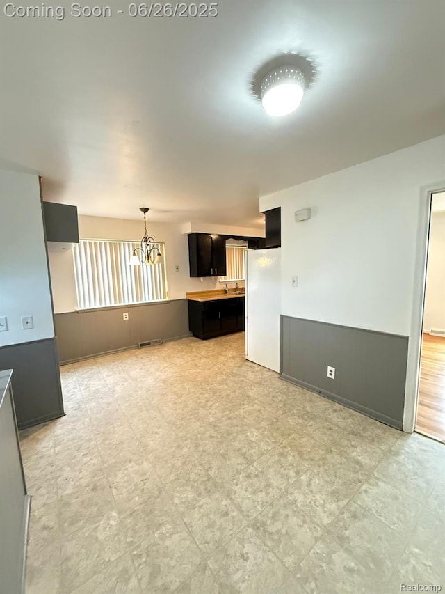 11522 Gerald Dr, Warren, MI 48093 - unfurnished living room featuring a chandelier