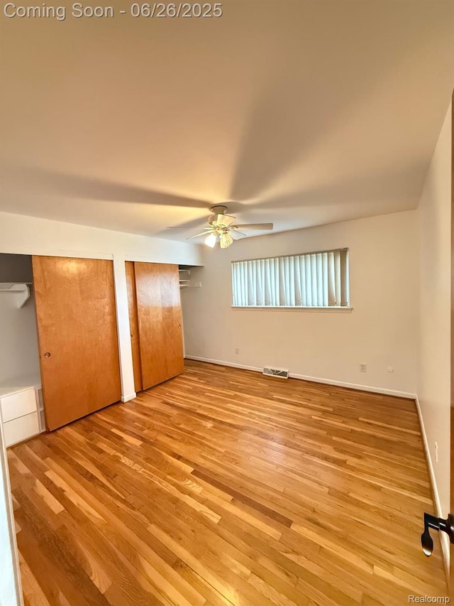11522 Gerald Dr, Warren, MI 48093 - unfurnished bedroom featuring wood finished floors, multiple closets, and a ceiling fan