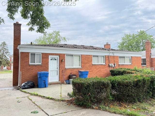 11522 Gerald Dr, Warren, MI 48093 - view of front facade with a chimney and brick siding