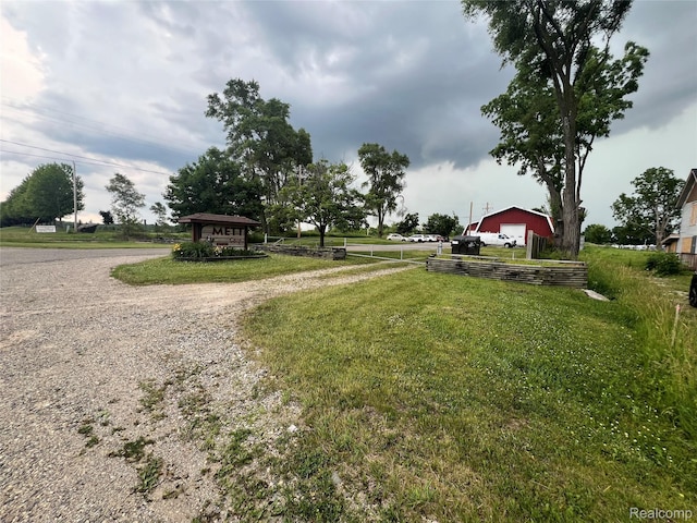 6737 Oak Grove Rd, Howell, MI 48855 - view of yard featuring driveway and a detached garage