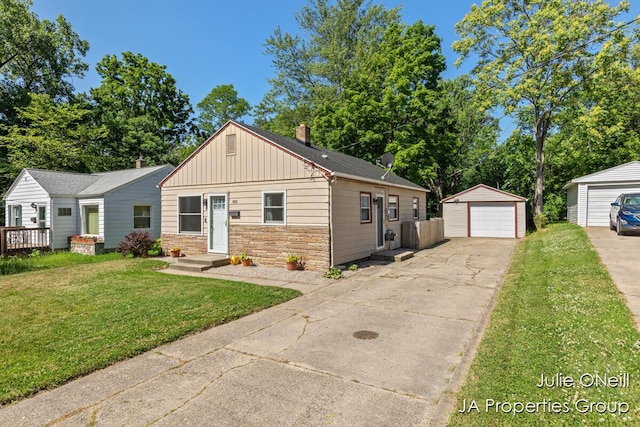 1035 Eastern Ave NE, Grand Rapids, MI 49503 - bungalow featuring board and batten siding, a detached garage, driveway, an outdoor structure, and a front yard