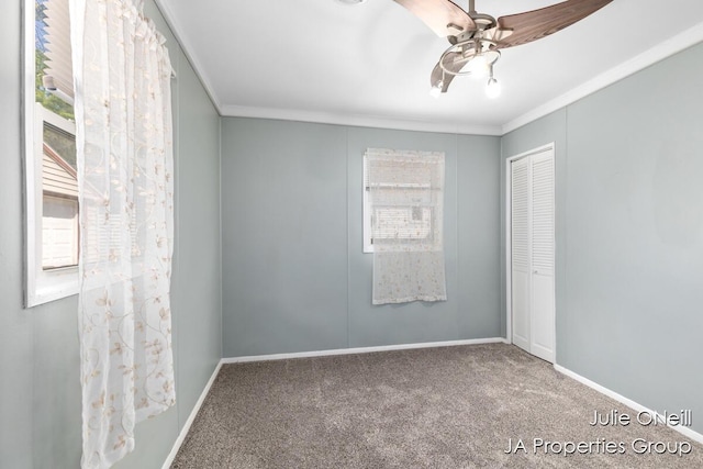 1035 Eastern Ave NE, Grand Rapids, MI 49503 - spare room featuring carpet flooring, a ceiling fan, and ornamental molding