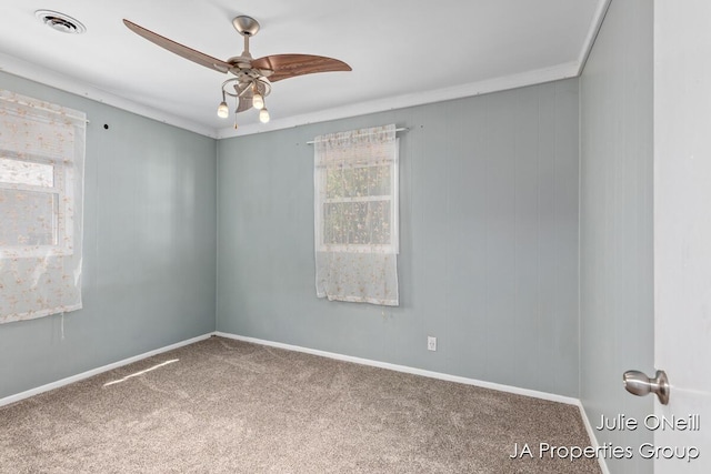 1035 Eastern Ave NE, Grand Rapids, MI 49503 - empty room featuring plenty of natural light, carpet flooring, a ceiling fan, and ornamental molding