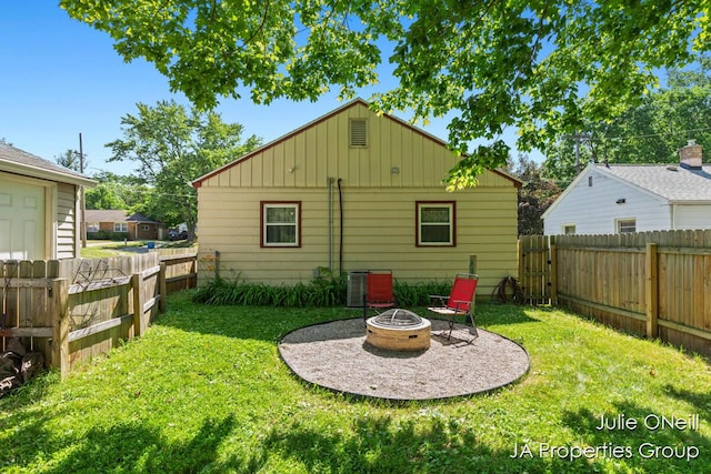 1035 Eastern Ave NE, Grand Rapids, MI 49503 - back of property with an outdoor fire pit, board and batten siding, and a fenced backyard