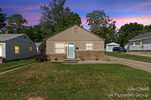 1035 Eastern Ave NE, Grand Rapids, MI 49503 - bungalow-style home with stone siding, a lawn, a garage, and board and batten siding