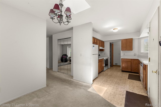 31450 Orchard Brook Ct Unit 8, Farmington Hills, MI 48336 - kitchen with white appliances, brown cabinets, a chandelier, and light countertops