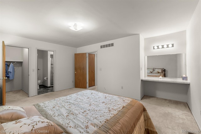 31450 Orchard Brook Ct Unit 8, Farmington Hills, MI 48336 - bedroom with light carpet, a spacious closet, and ensuite bathroom