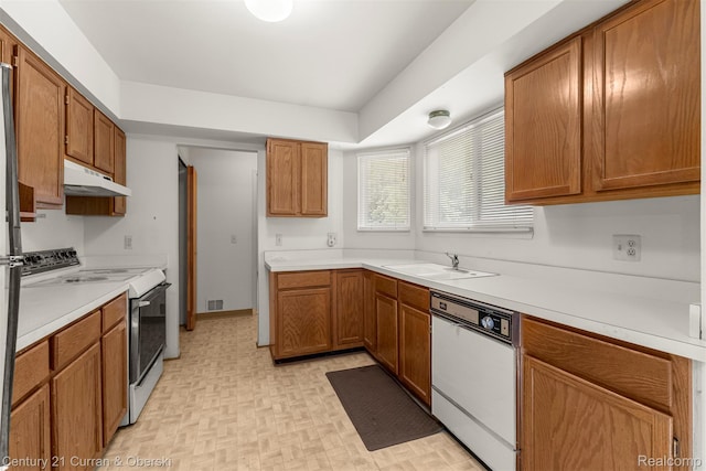 31450 Orchard Brook Ct Unit 8, Farmington Hills, MI 48336 - kitchen with white appliances, under cabinet range hood, light countertops, and brown cabinetry